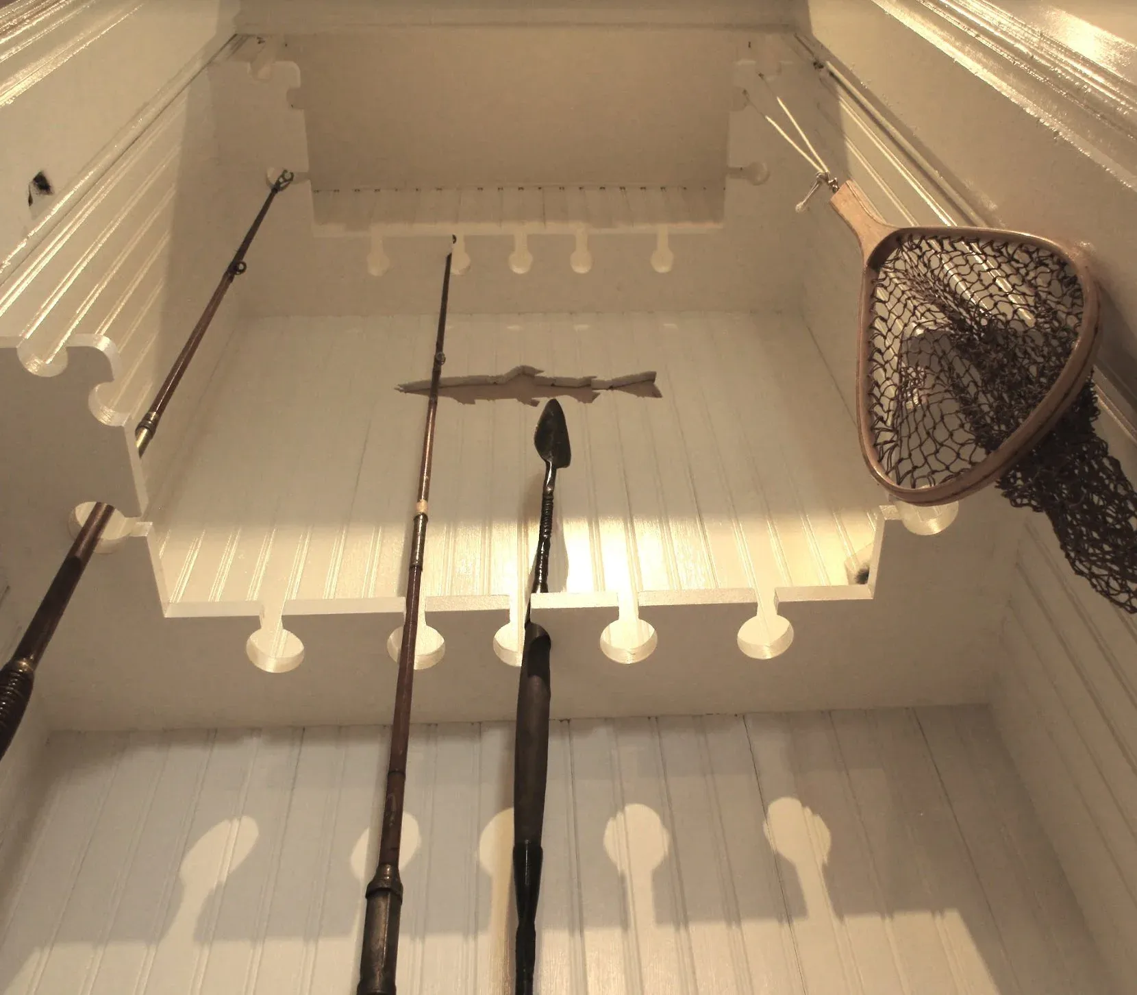 Antique fishing rods and net displayed inside the Fisherman's Lodge